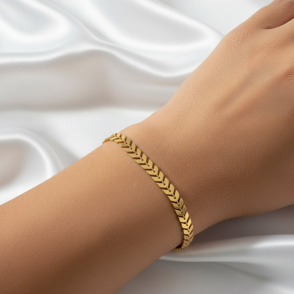 Gold plated bracelet on a person's wrist featuring hypoallergenic jewelry