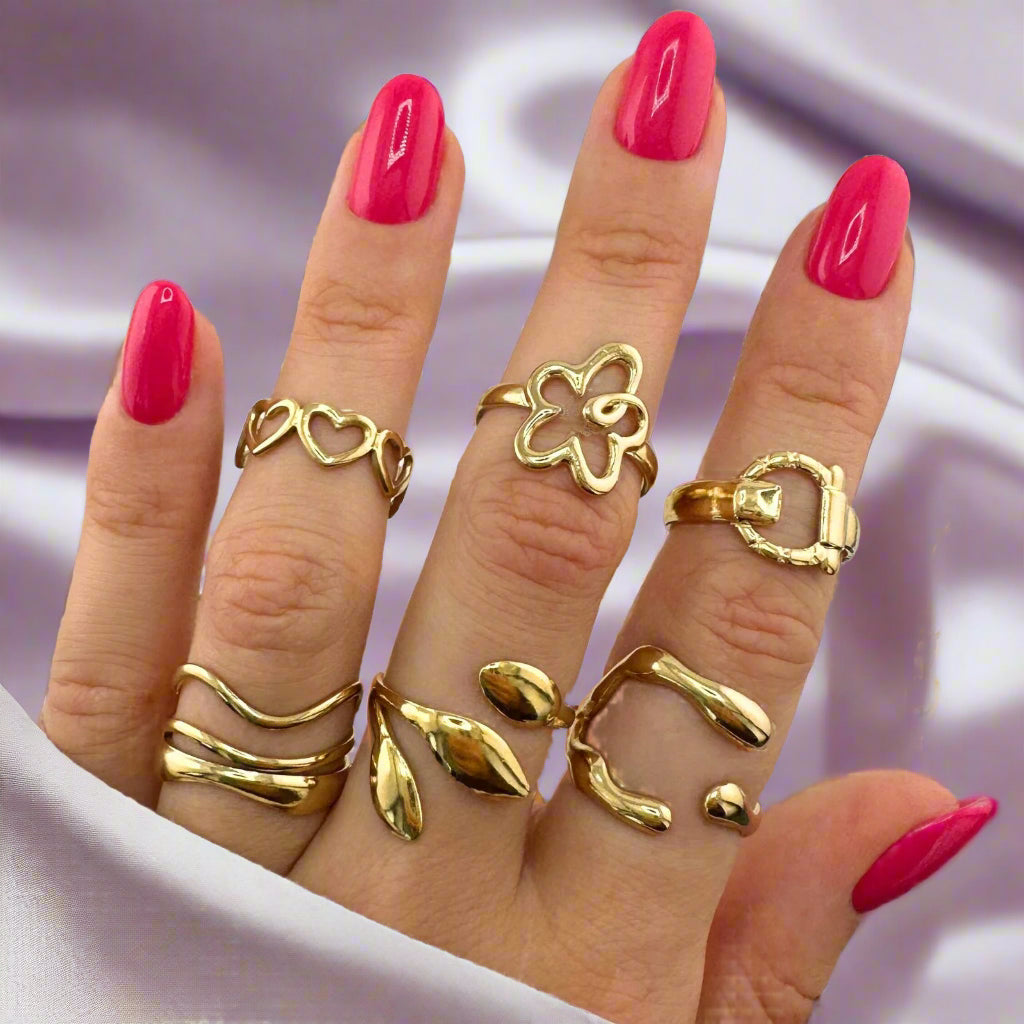 Hand wearing multiple gold plated rings made of stainless steel