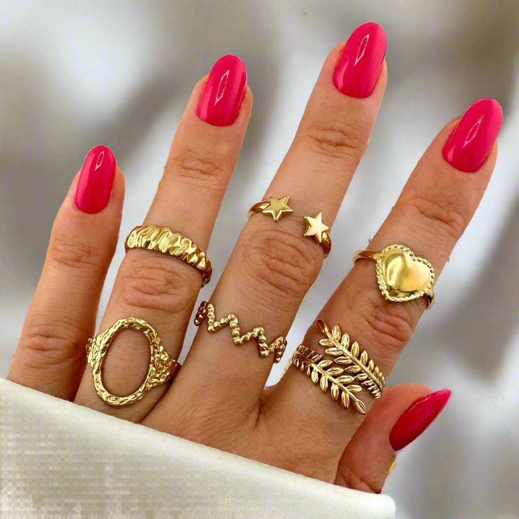 Hand with gold plated and stainless steel rings with waterproof and hypoallergenic features