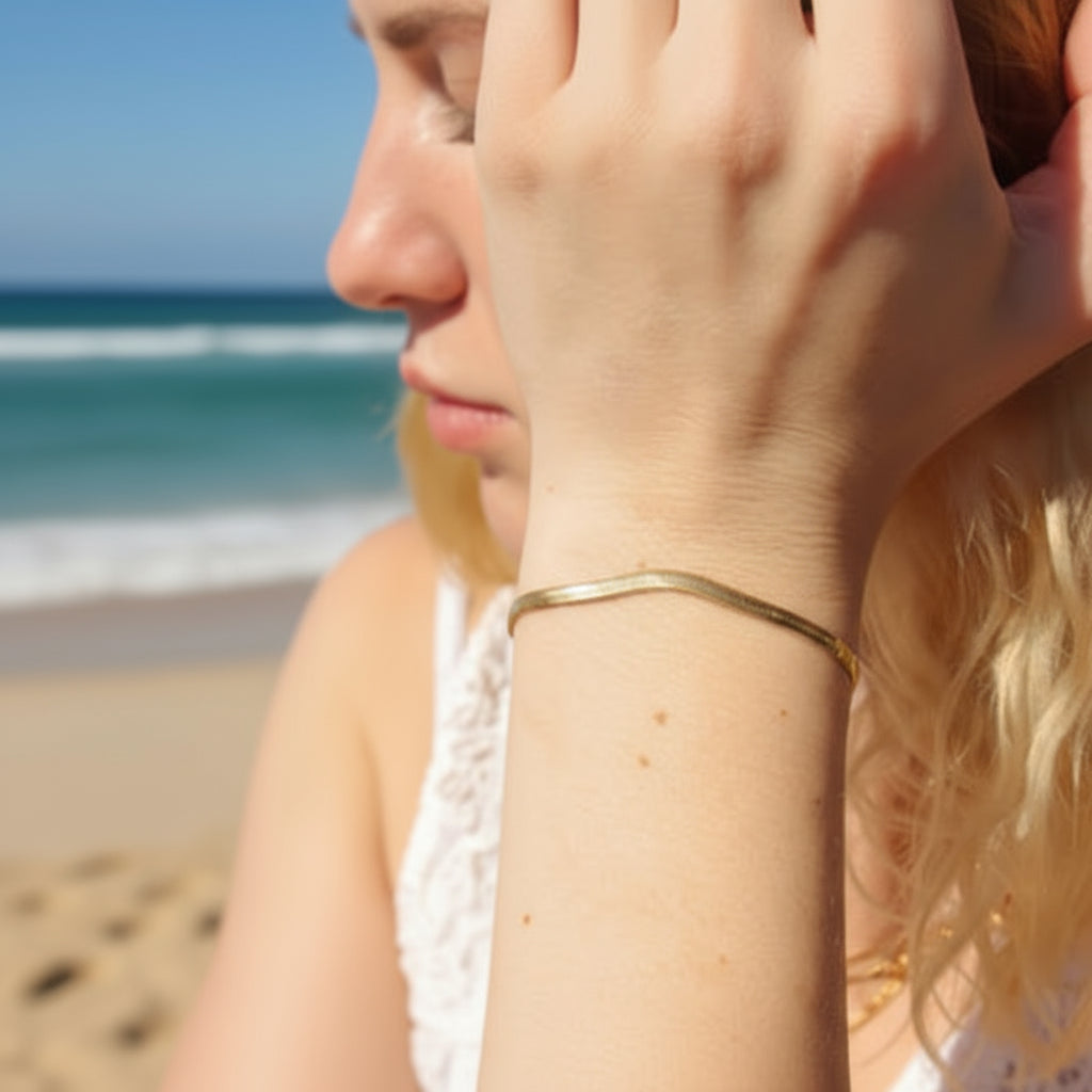 Close-up of a person wearing a gold plated bracelet with sweatproof and waterproof features