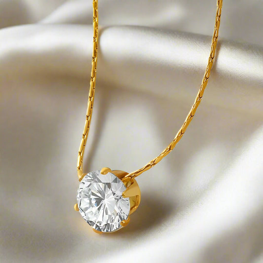 Gold necklace with a large clear gemstone featuring titanium steel jewelry