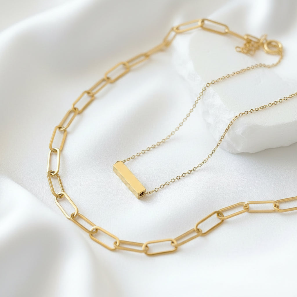 Gold bar necklace on a white background