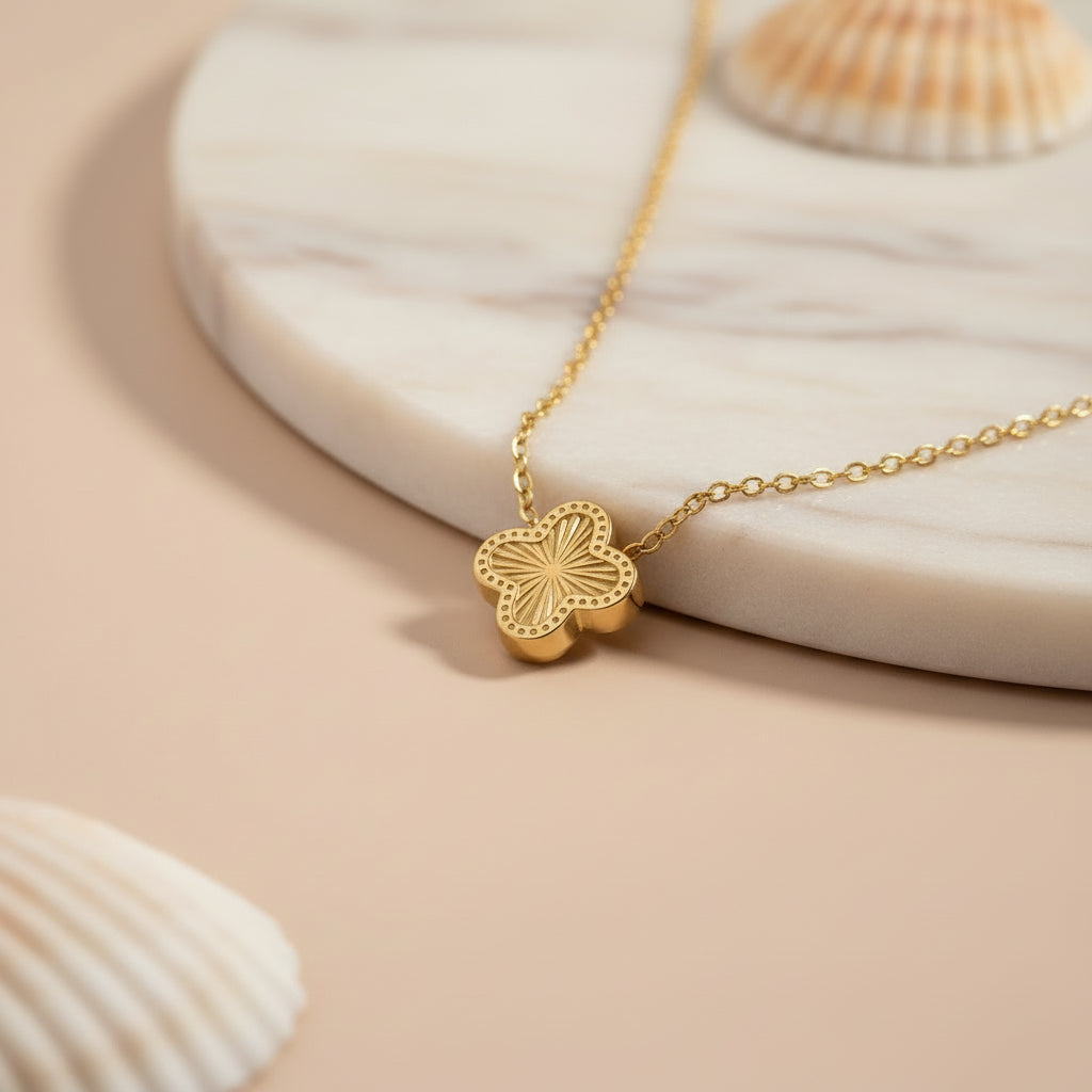 4 leaf clover necklace with a clover leaf-shaped pendant on a beige background