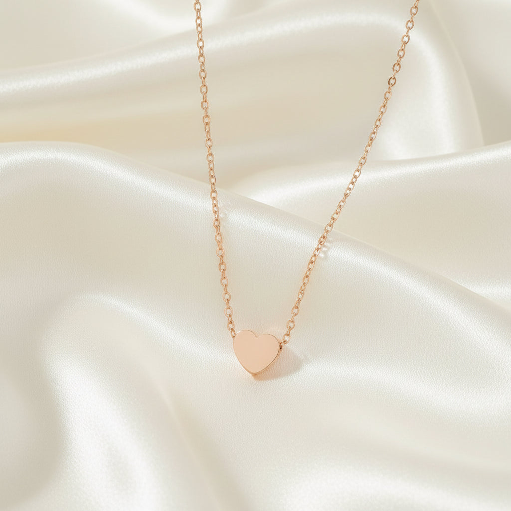 Rose gold heart-shaped pendant necklace on a white background
