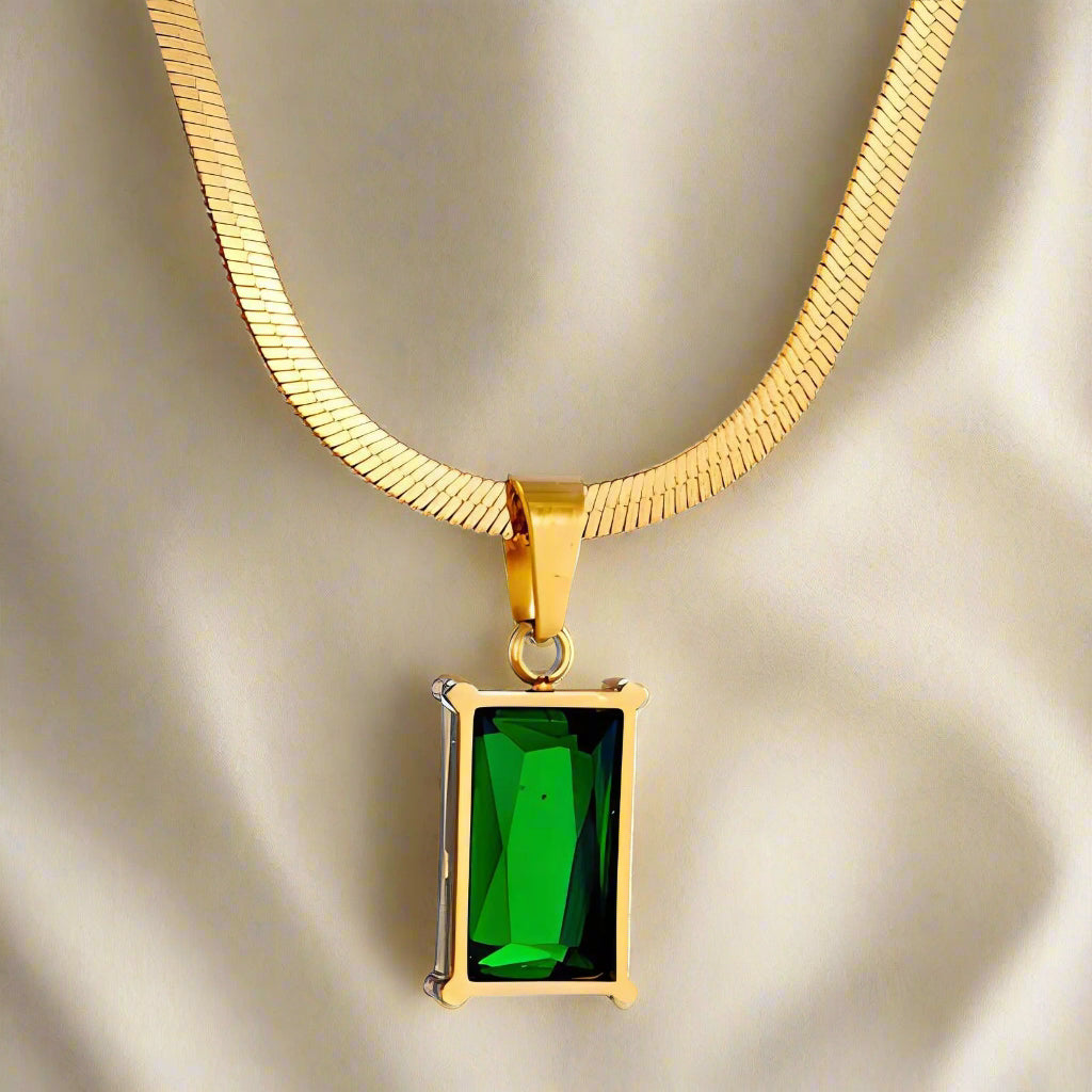 herringbone necklace with green emerald and snake chain