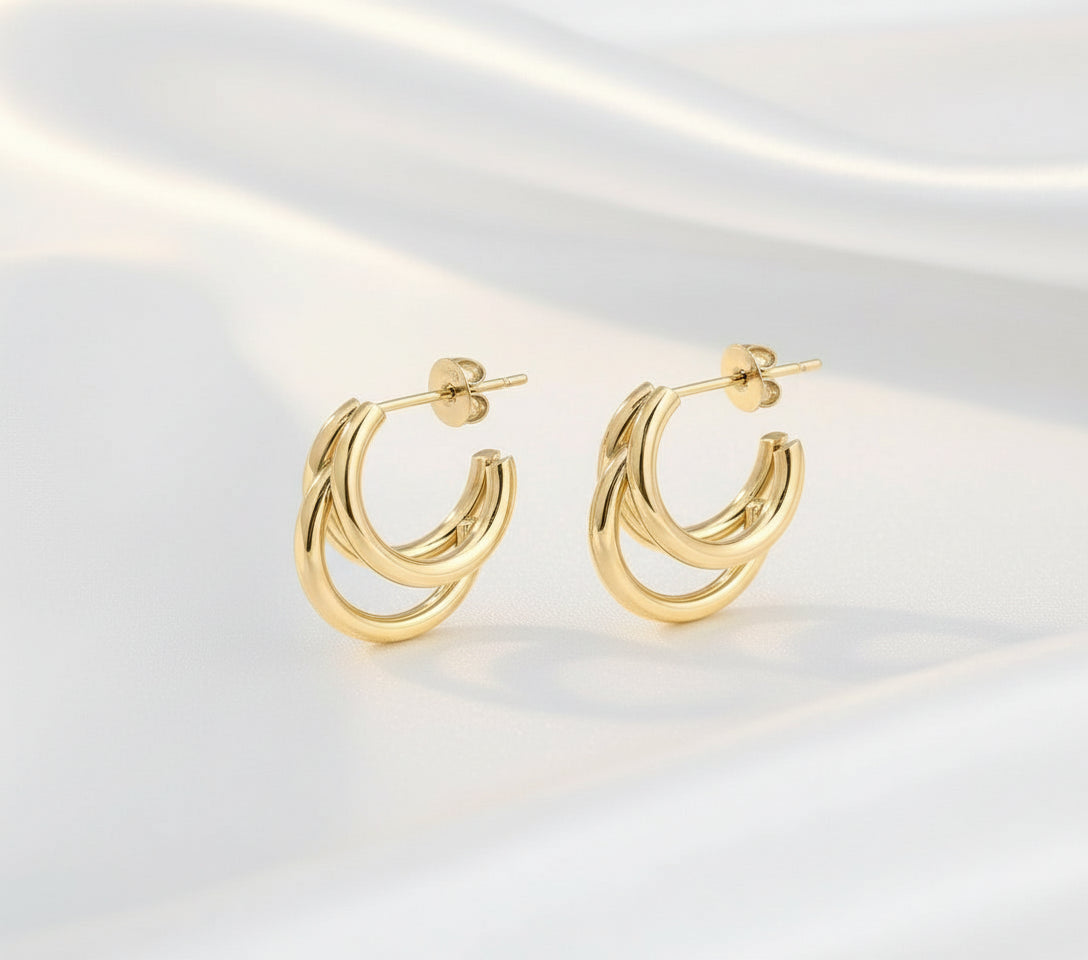 huggie earrings on a white background