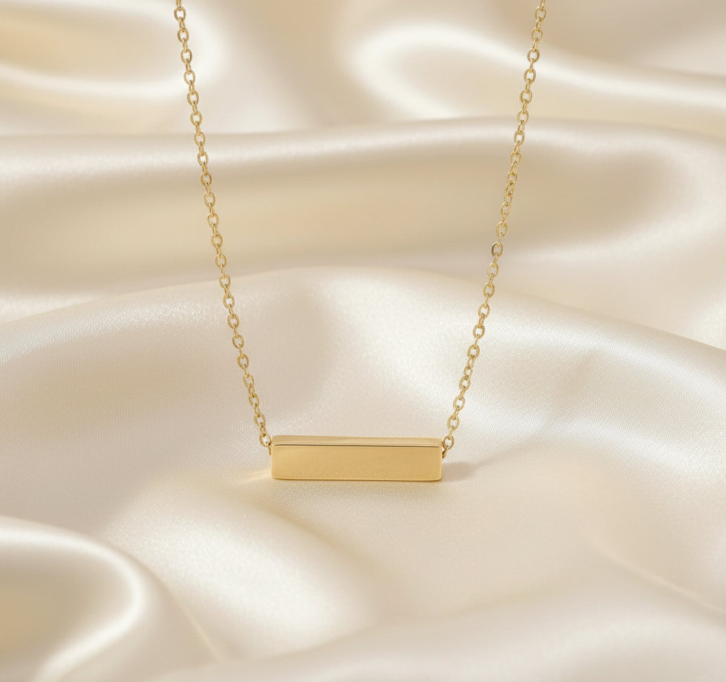 Gold bar necklace on a white background with color swatches below.